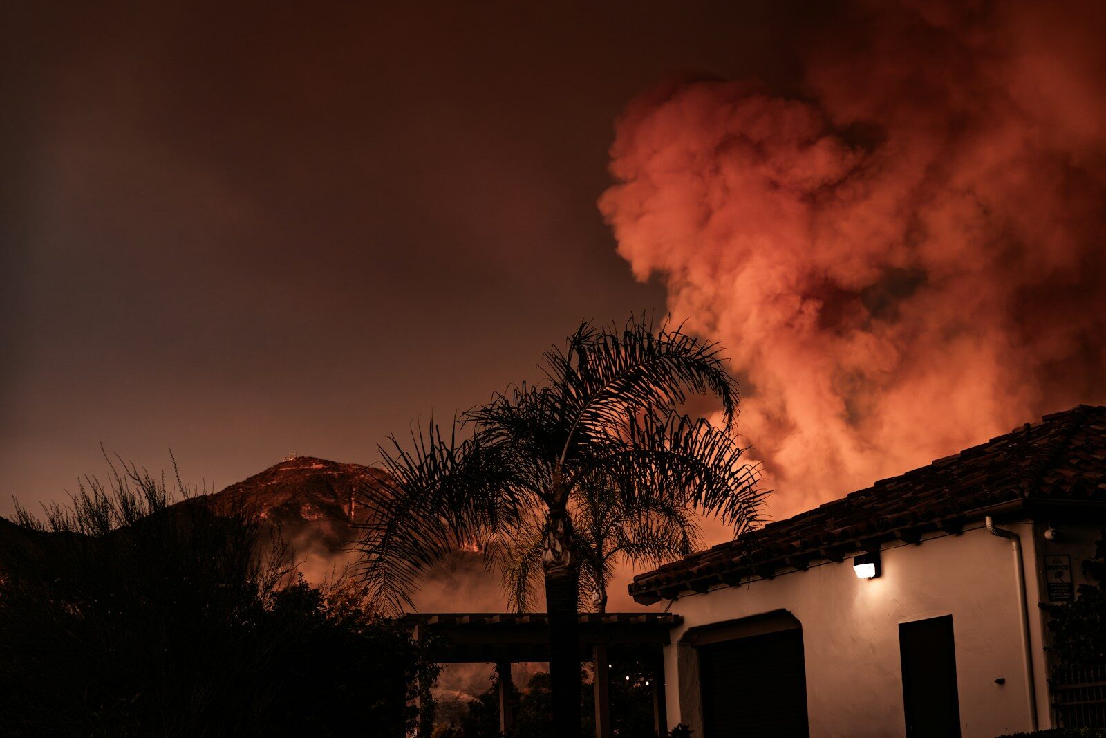 A large plume of smoke billowing out of a building